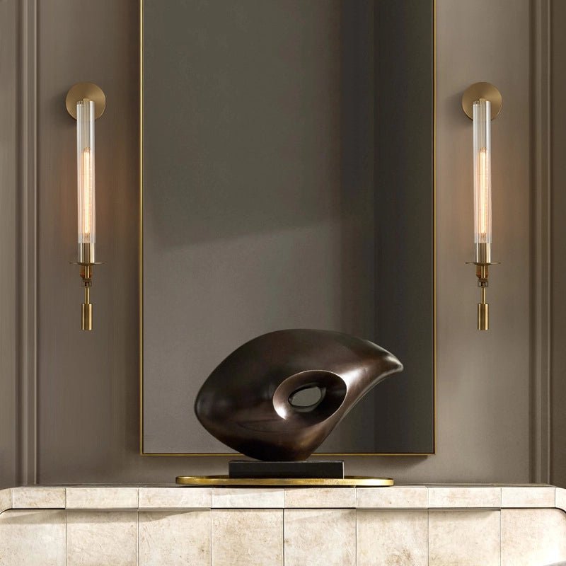 Brass sconces mounted in pairs with ribbed glass shades