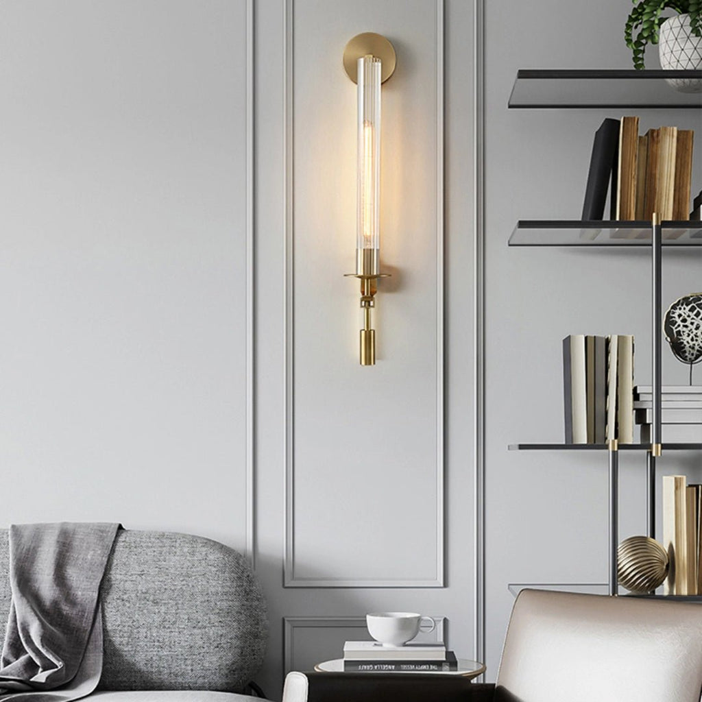 Brass sconces casting candle-like light on a wall