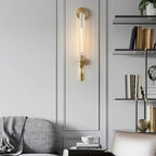 Brass sconces casting candle-like light on a wall