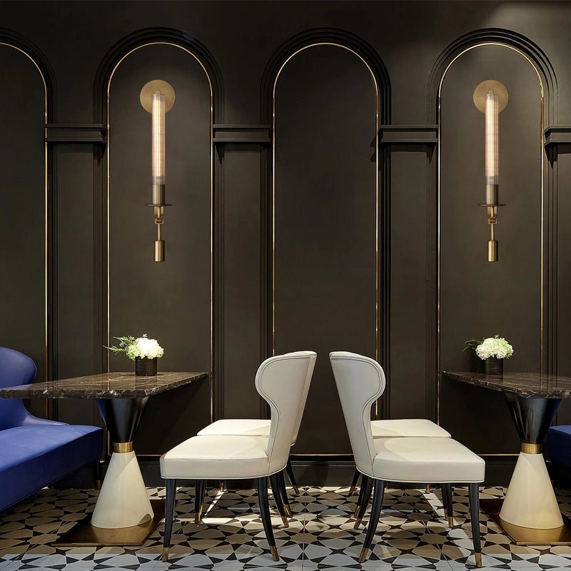 Brass sconces with ribbed glass shades in a styled interior
