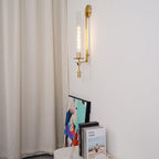 Brass wall lamp with ribbed glass shade close up detail