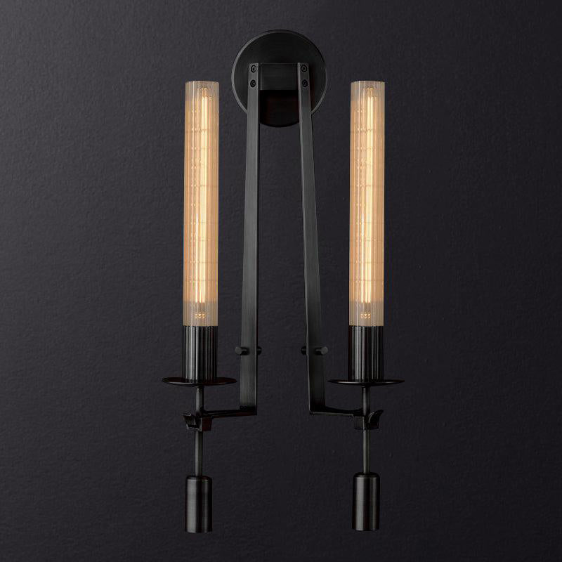 Ribbed glass wall sconce with warm filament bulb glowing
