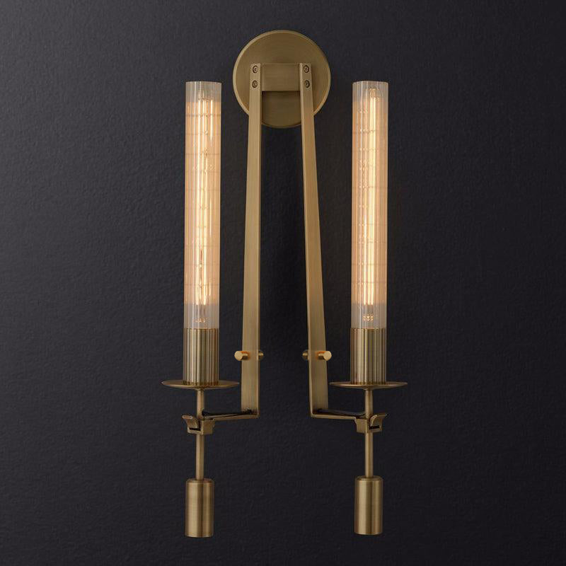 Brass wall lamp casting shimmering light along a wall