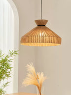 Close view of this Clérachic pendant's fluted jute cone, a pampas grass stem visible in the corner below.