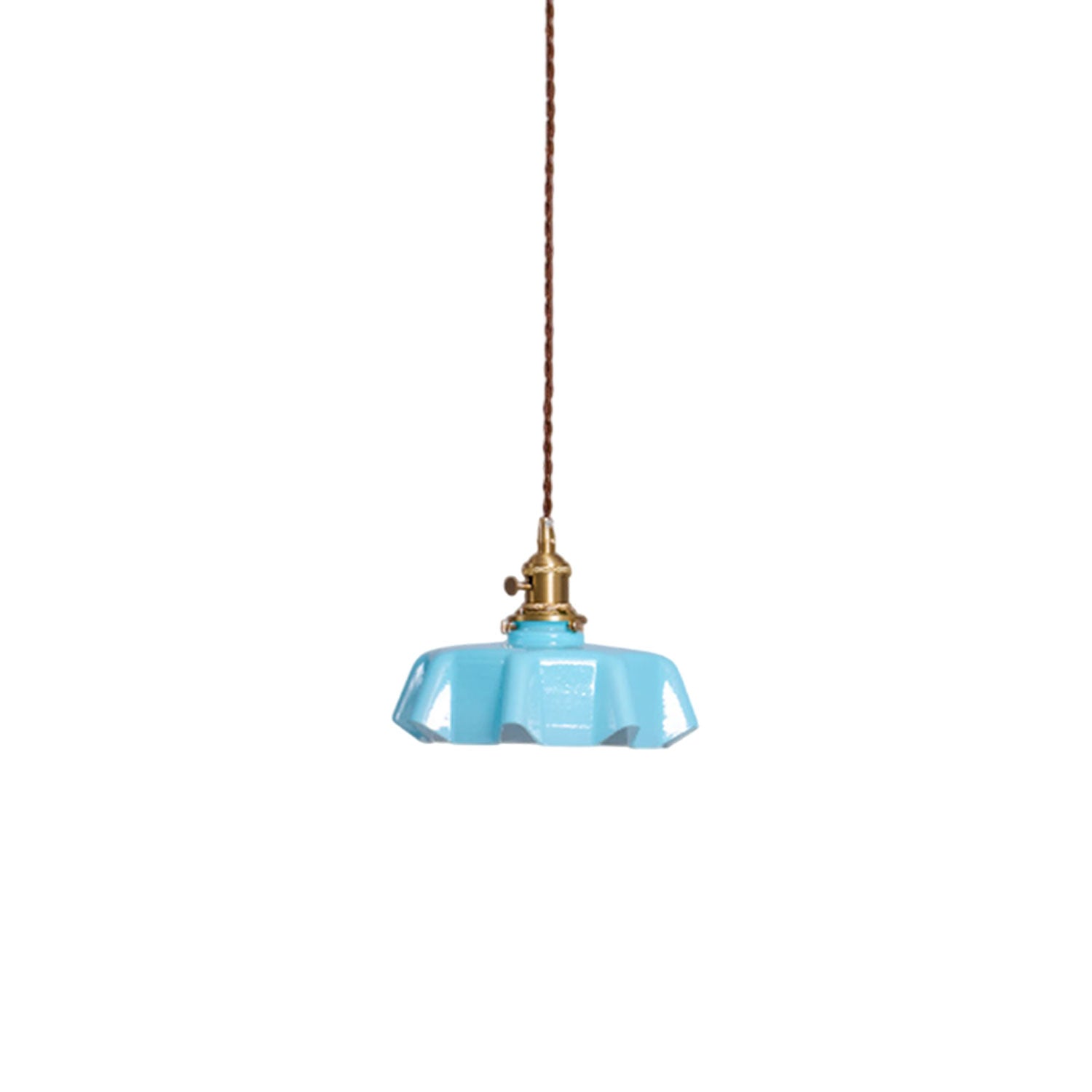 Pleated glass pendant light with warm brass fitting lit softly