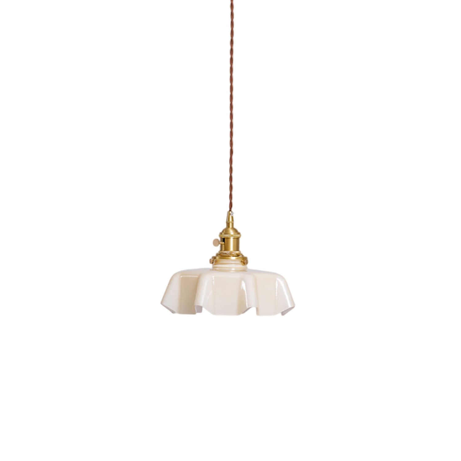 Pleated glass pendant light glowing warmly over a table