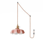 The plug-in diagram for this Clérachic pendant shows a twisted brown cord running from ceiling hook to wall plug, ending in the pink shade.