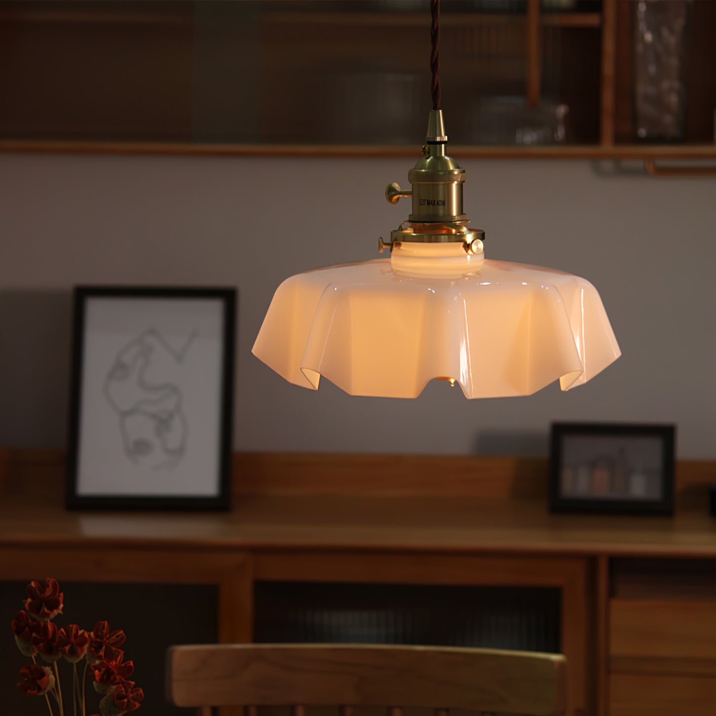 Pleated glass pendant light glowing above a kitchen worktop