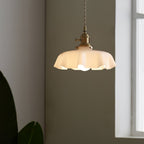 French Flower pendant light with pleated shade lit warmly