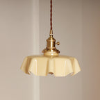 Pleated glass pendant light casting soft dappled light