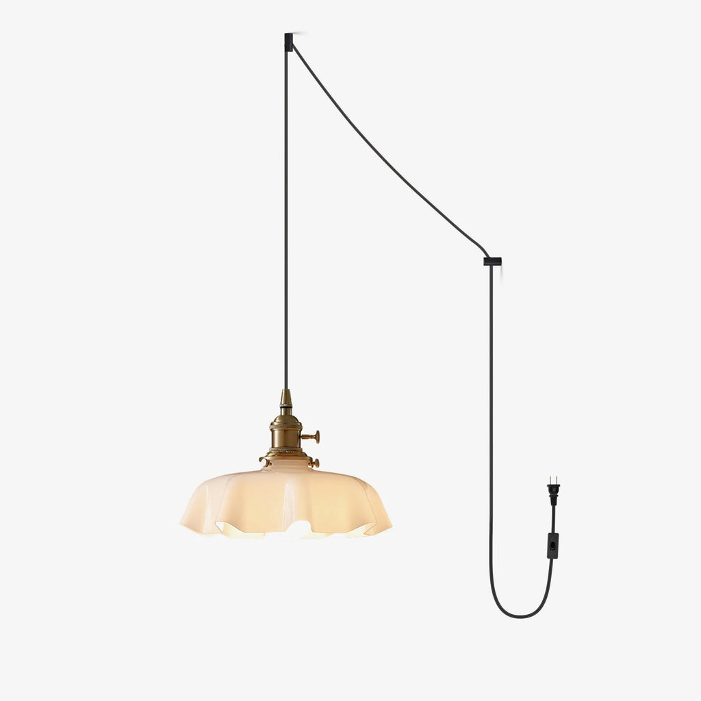 A wall-mounted diagram for this Clérachic pendant shows the cord running from ceiling hook to plug, ending in its beige pleated shade.