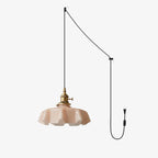 This Clérachic pendant's plug-in diagram routes a black cord from ceiling hook to wall plug, ending in the blush pink shade.