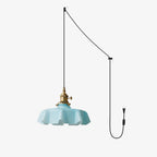 This Clérachic pendant's plug-in diagram routes a black cord from ceiling hook to wall plug, ending in the blue pleated shade.