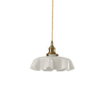 A plain white studio shot shows this Clérachic pendant's white pleated glass shade and brass fitter on its twisted cord.