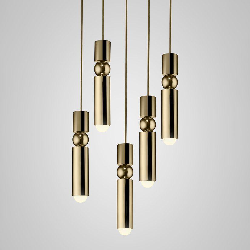 Geometric pendant light cluster glowing in a living space