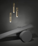 Cylinder cluster pendant light suspended over a dining setting