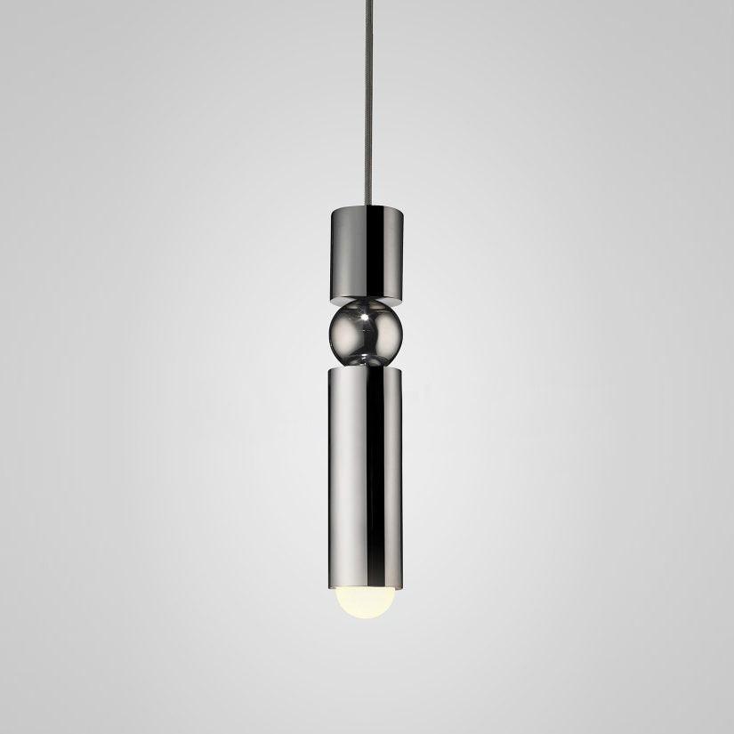 Cylinder cluster pendant light suspended over a dining table
