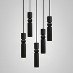 Geometric pendant light with cylinders over a stairwell
