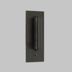Front view of this Clérachic reading light in bronze, unlit, head down, on a plain grey background.