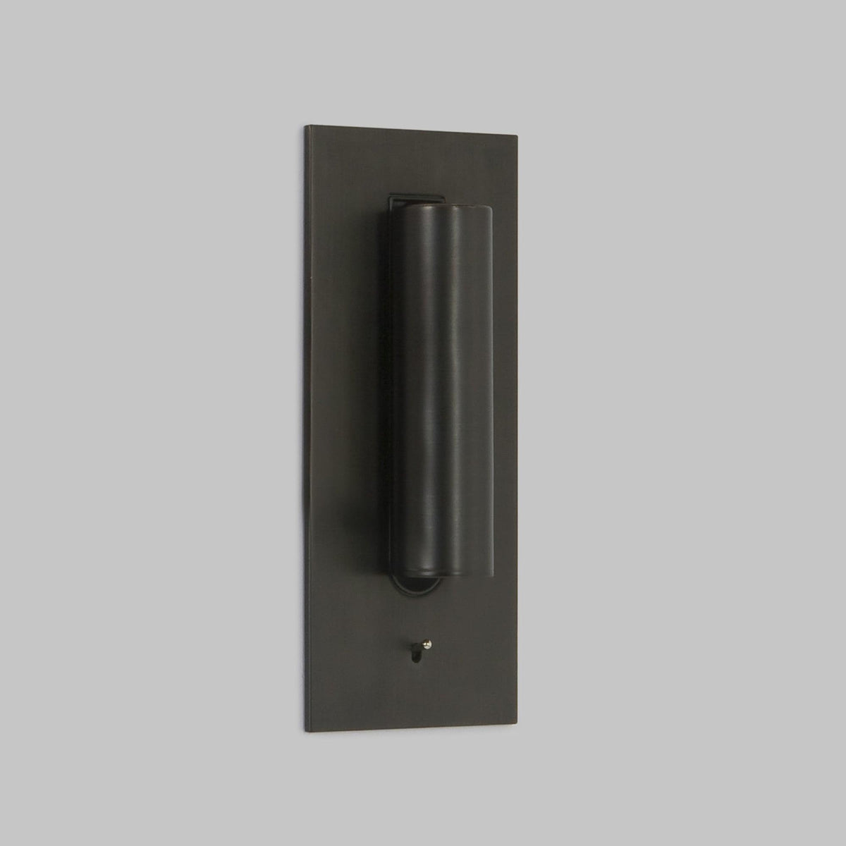 Front view of this Clérachic reading light in bronze, unlit, head down, on a plain grey background.