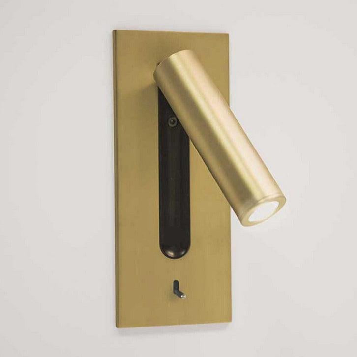 This Clérachic reading light in copper, lit, mounted on a plain wall with its head turned to the side.