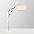 Clérachic black arc floor lamp shown close-in on a plain white background, its linen shade angled toward the camera.