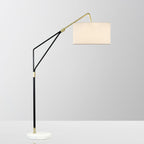 Clérachic black arc floor lamp shown close-in on a plain white background, its linen shade angled toward the camera.