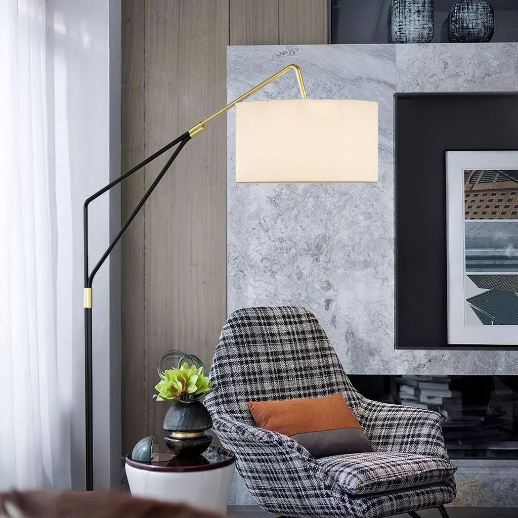 Clérachic black arc floor lamp beside a checked armchair, set against a marble accent wall with a small potted plant.