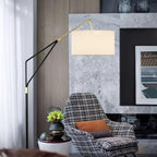 Clérachic black arc floor lamp beside a checked armchair, set against a marble accent wall with a small potted plant.
