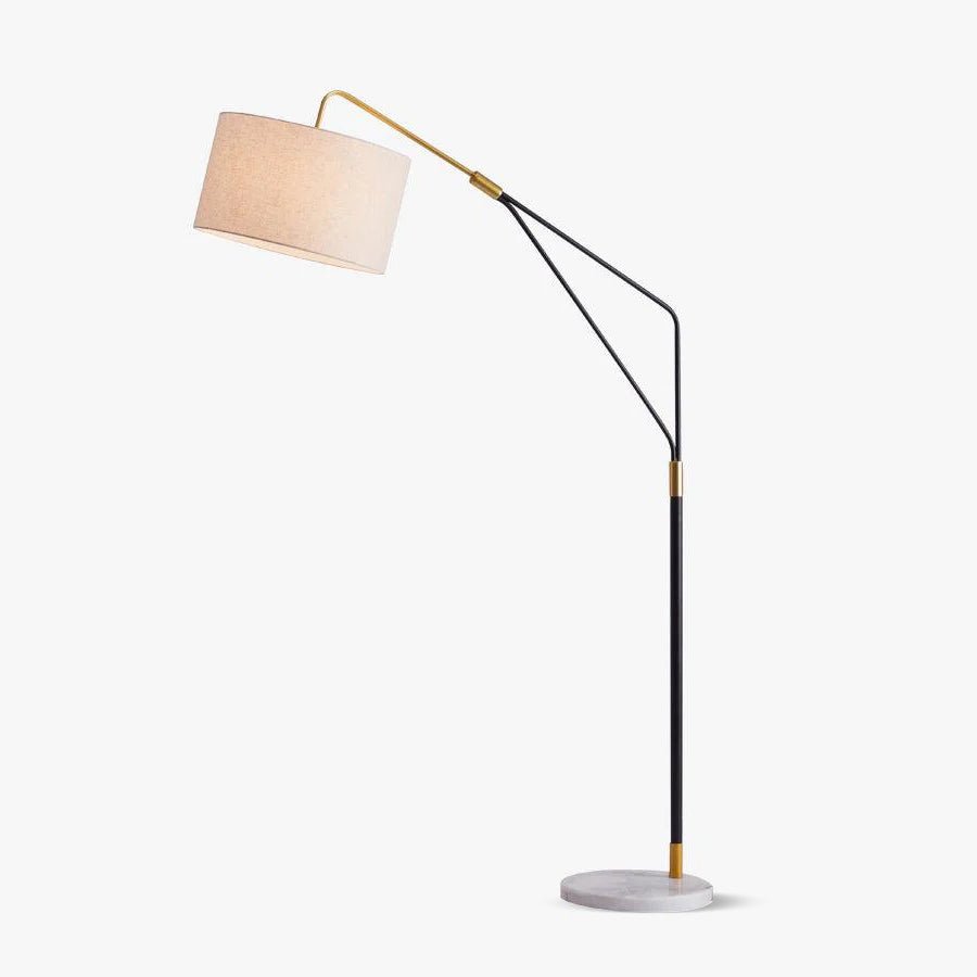 Clérachic black arc floor lamp with a linen drum shade on a round marble base, alone on a plain white background.