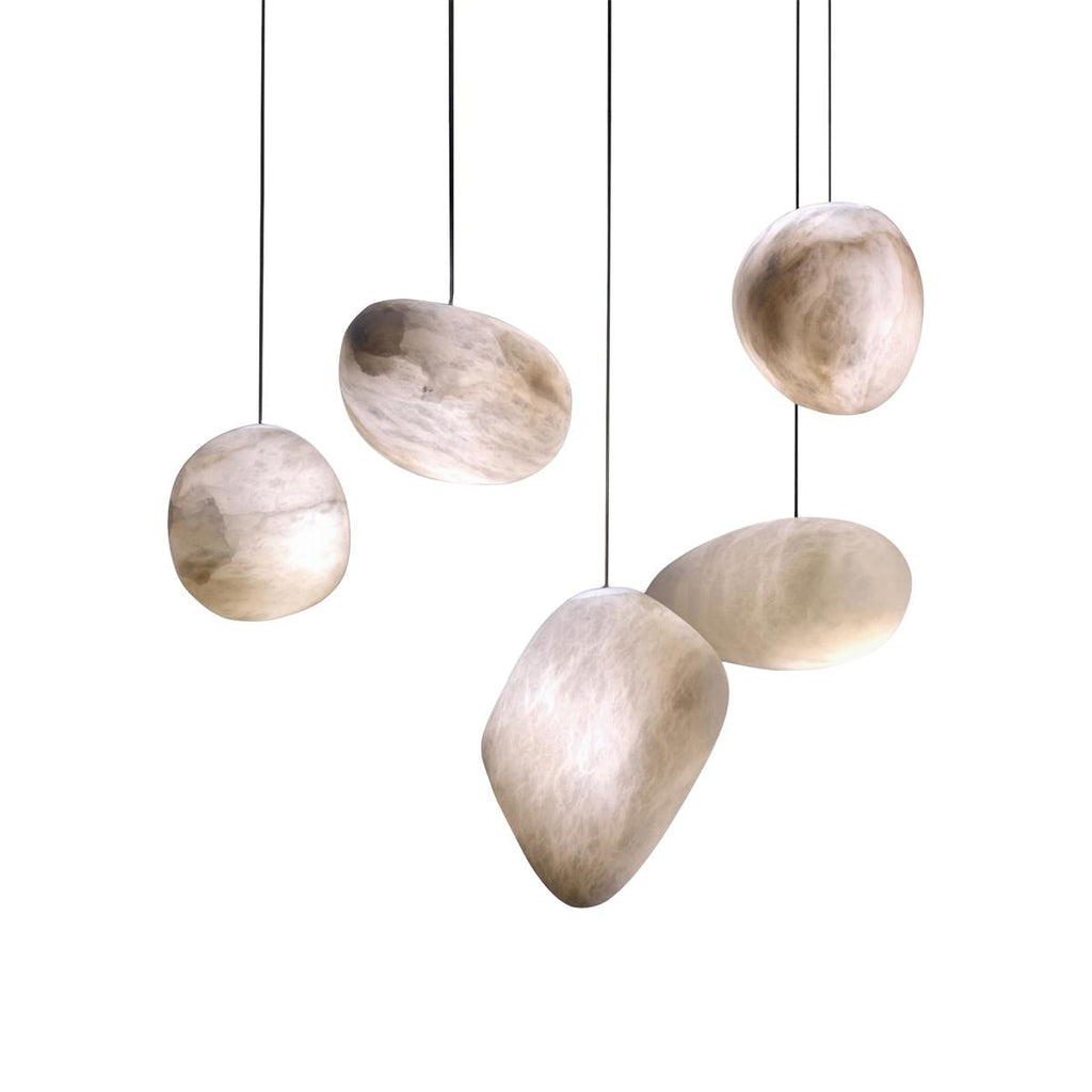 Five alabaster shades in different sculptural forms hung at staggered heights and lit