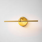 Front-on view of this gold-finish Clérachic wall light, lit, the warm glow spreading across the wall beneath the slim bar.