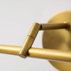 Close view of the folding hinge mechanism on this Clérachic wall light's gold-finish arm.