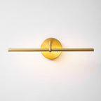 Straight-on, this gold-finish Clérachic wall light glows with the bar centred through its round canopy.