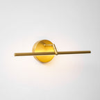This gold-finish Clérachic wall light glows at an angle, the offset bar casting warm light along the wall.