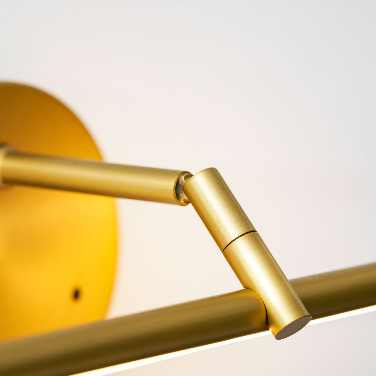 Close view from below of the pivot joint where the arm hinges against the canopy of this Clérachic wall light.