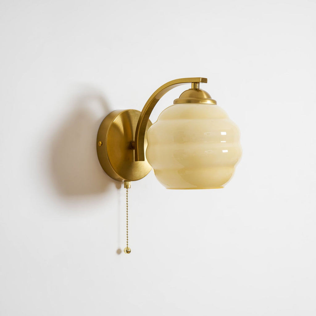 Gatsby wall lamp with rounded glass shade switched on