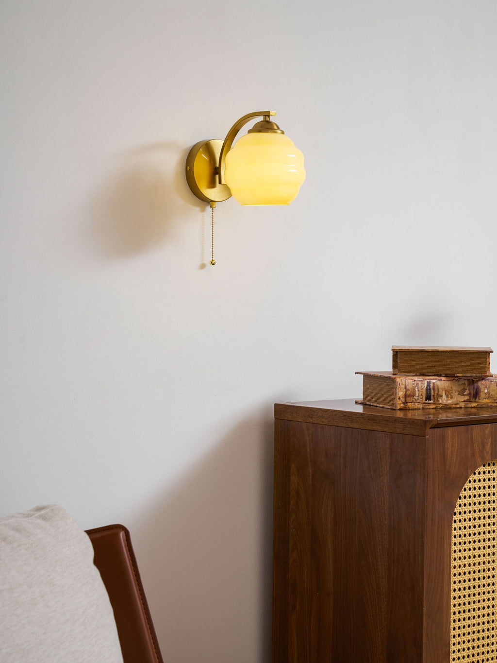 Gatsby wall lamp glowing softly above a side table