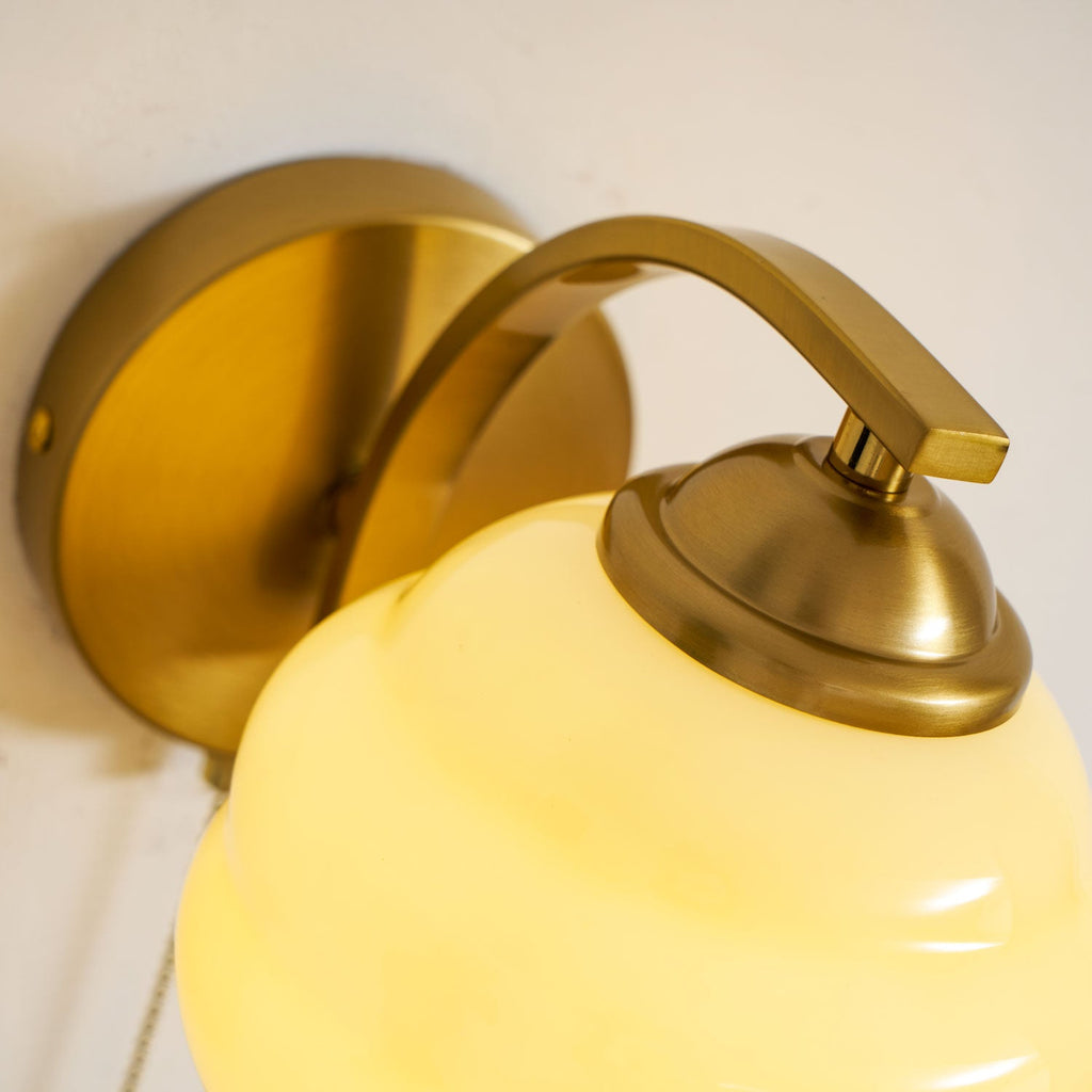 Gatsby wall lamp with glass shade beside a doorway