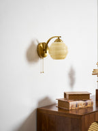 Gatsby wall lamp glowing beside neutral interior decor
