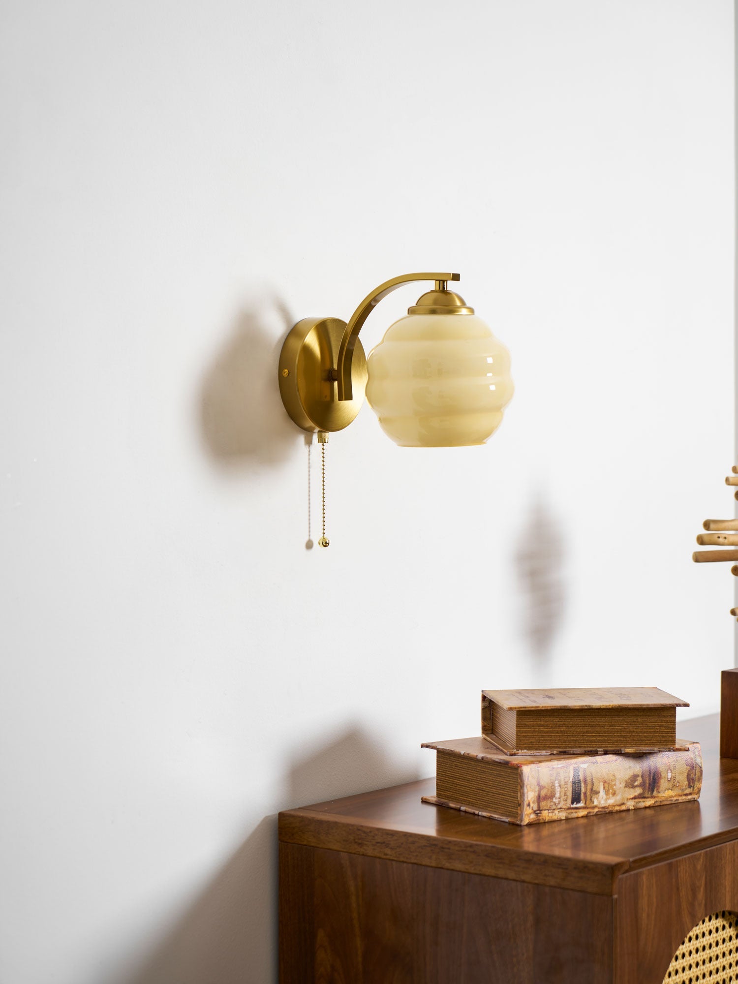 Gatsby wall lamp glowing beside neutral interior decor