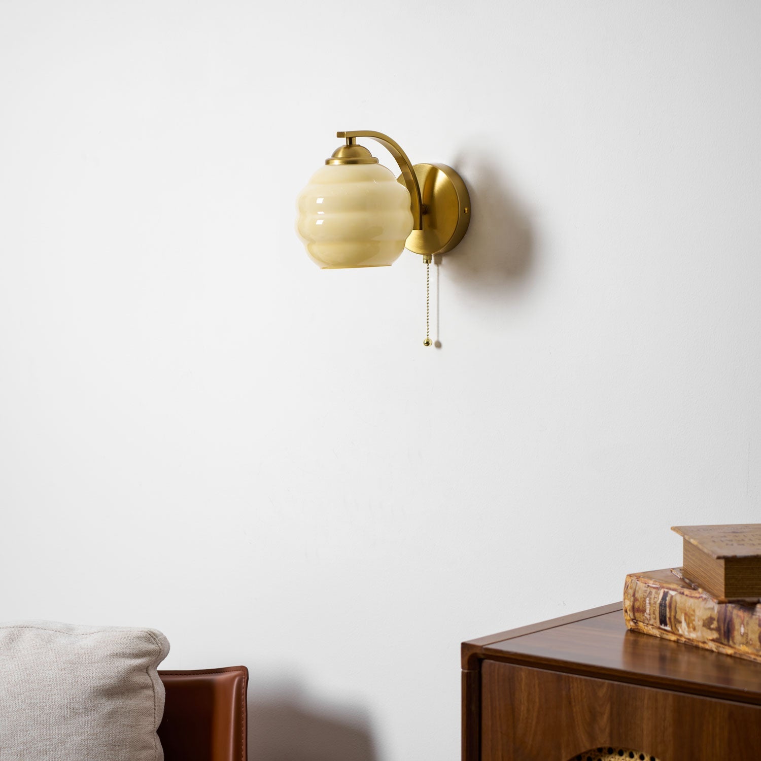 Gatsby wall lamp lit softly against a light wall