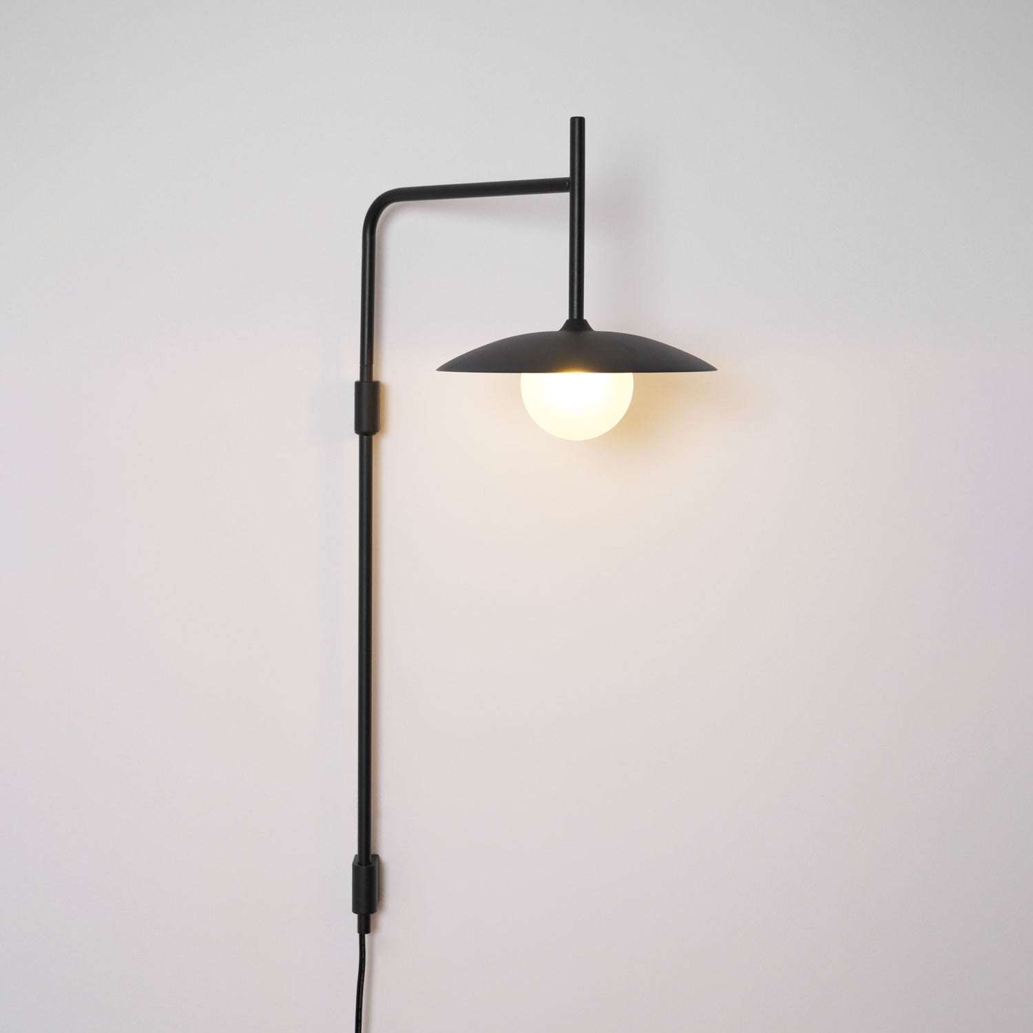 Adjustable swing arm wall lamp with frosted glass shade