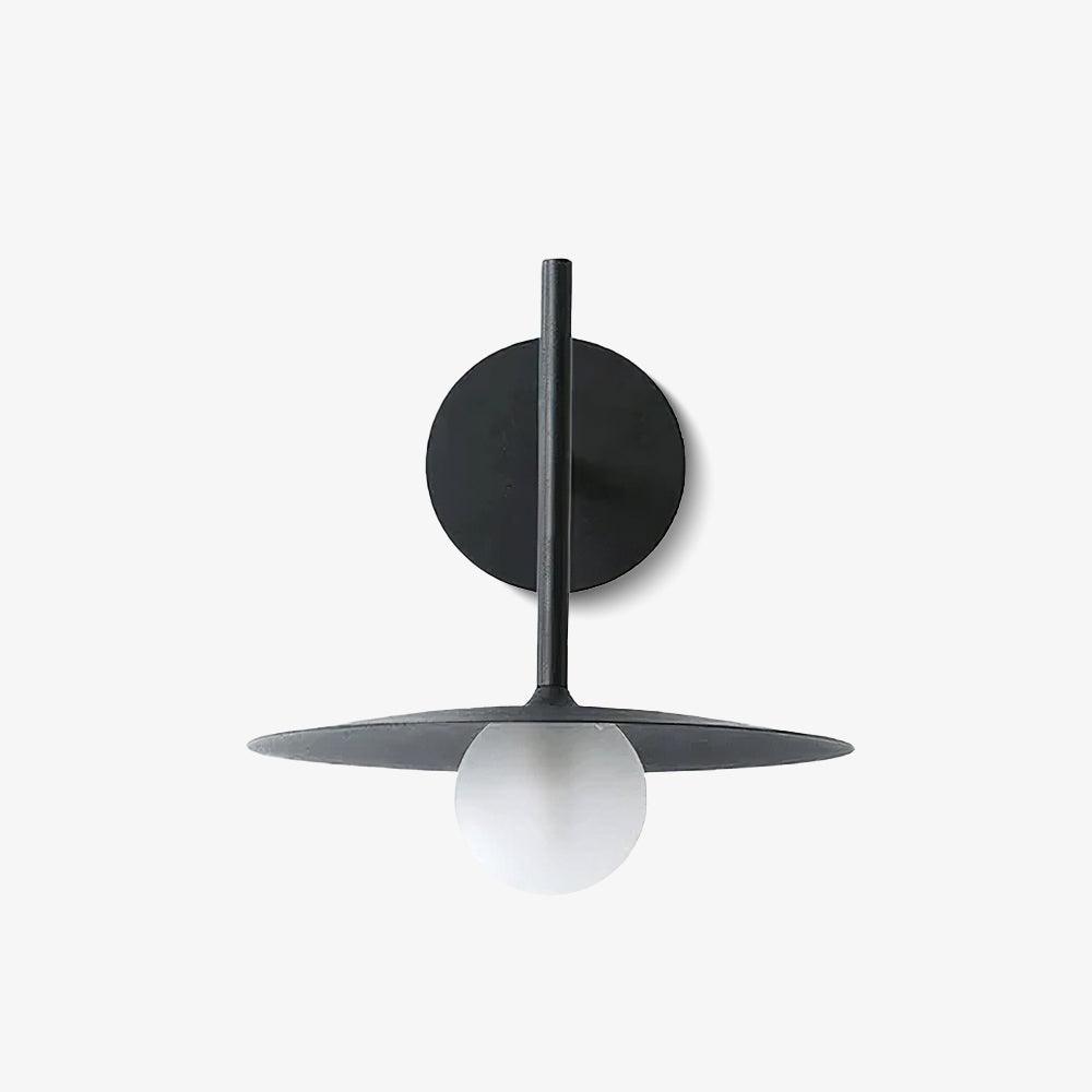 Front view of this black Clérachic wall light, disc shade and round wall plate shown unlit.