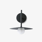 Front view of this black Clérachic wall light, disc shade and round wall plate shown unlit.