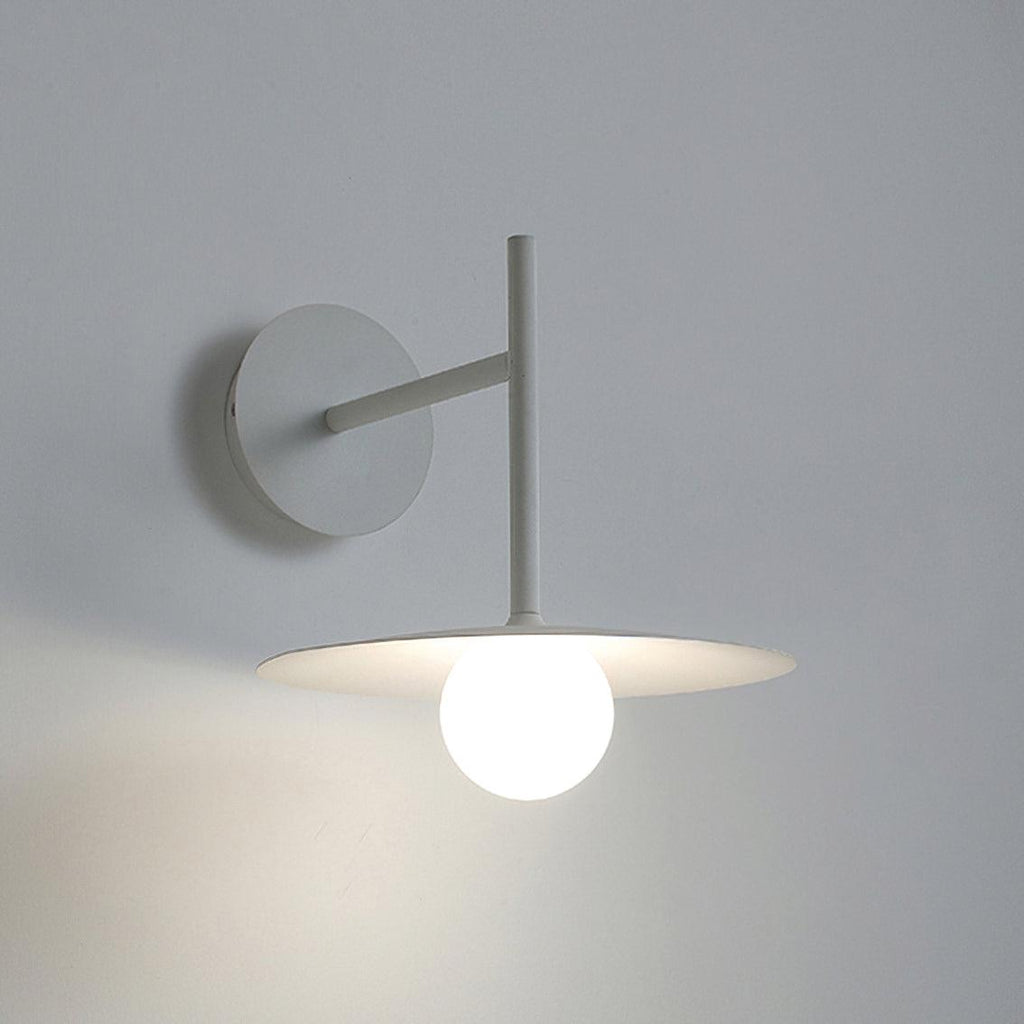 Against a plain grey backdrop, this white Clérachic wall light glows softly.