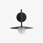 Angled studio view of this black Clérachic wall light, shown unlit against a plain backdrop.
