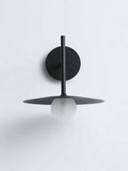 Studio view of this black Clérachic wall light, shown unlit against a plain white backdrop.