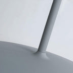 Close view of the angled arm meeting the disc shade on this grey Clérachic wall light.