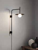 White swing arm wall lamp with frosted glass shade on wall